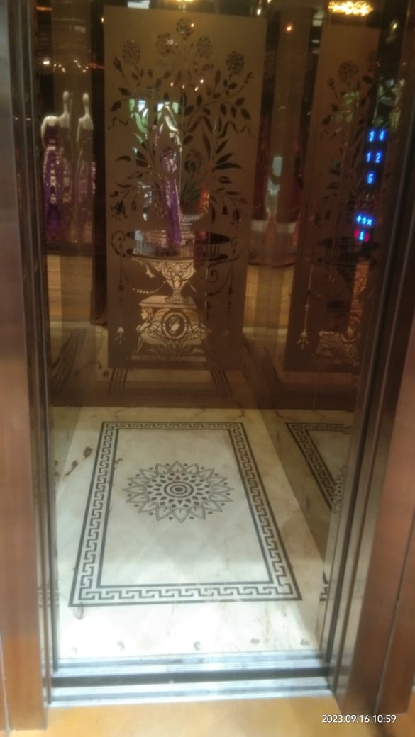 Elegant elevator with decorative panels and marble flooring