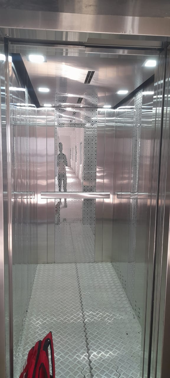 Large elevator with stainless steel interior and checkered floor plate