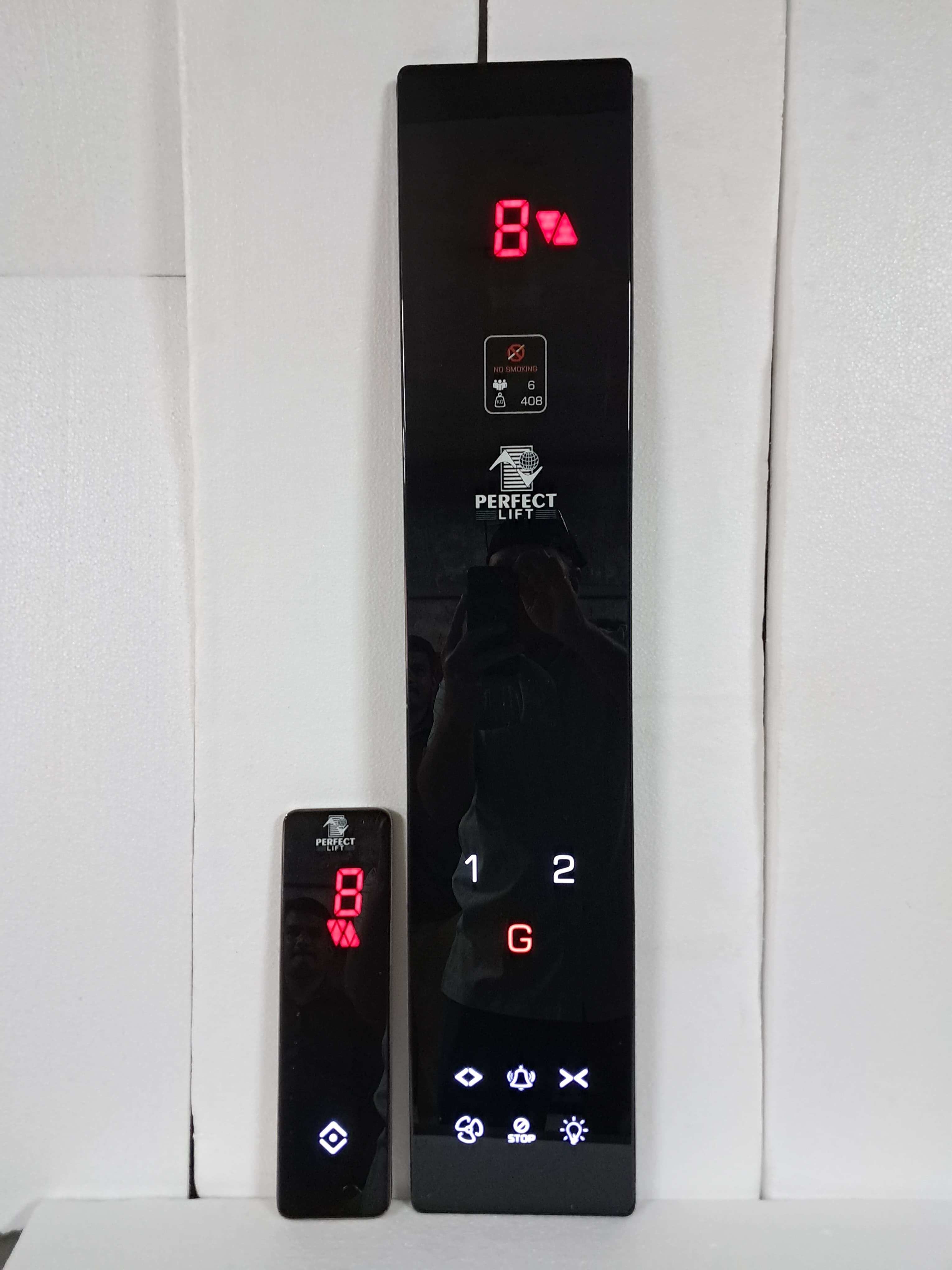 Tall and small elevator control panels with digital floor indicators, Perfect Lift branding, and illuminated buttons