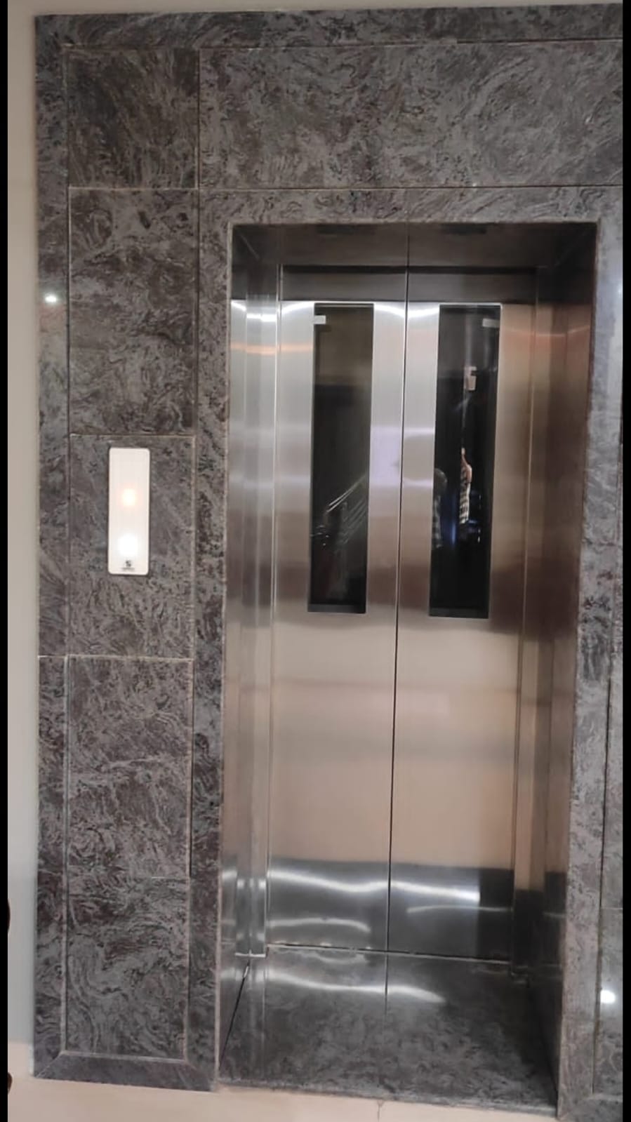 Stainless steel automatic door with marble surround