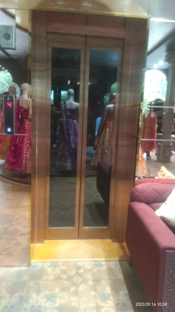Gold-framed glass automatic elevator door